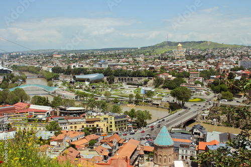 Spring view to historical part of the capital of Republic of Georgia. In the middle river Kura, Bridge of Peace. View from the Fortress Narikala photo