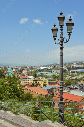 Spring view to historical part of the capital of Republic of Georgia. In the middle river Kura, Bridge of Peace. View from the Fortress Narikala photo