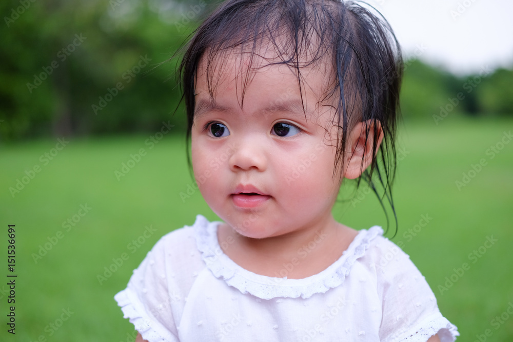 Cute Baby girl playing in the garden, close-up portrait, Portrait of Asian beautiful baby girl of 1 year and 3 months old. Cute Baby girl playing in the garden, close-up portrait, Portrait of Asian beautiful baby girl of 1 year and 3 months old.