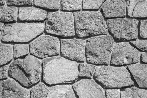 Rough gray stone wall, background texture