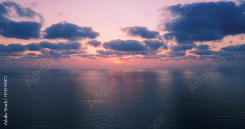 Brightly colored sunset over the calm Mediterranean Sea. Drone Point of View . Night