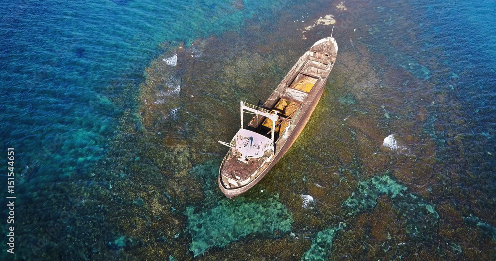  Beautiful seascape with old big, broken, rusty boat near the coast of Peyia, Cyprus. Ship graveyard. Famous landmark in the Mediterranean sea.