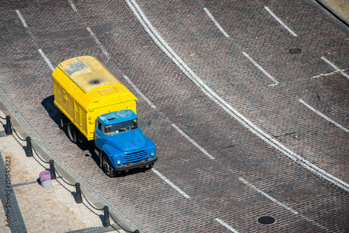 Yellow truck on the road view from above