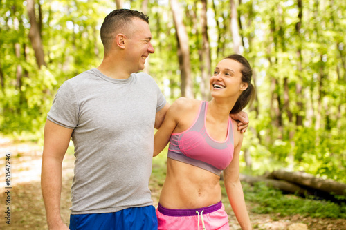 young happy fitness couple in forest