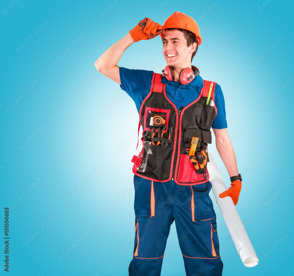 Handsome young handyman with a tool belt looking on a left. House renovation service. Building concept. Handsome young handyman with a tool belt looking on a left. House renovation service. Building concept.