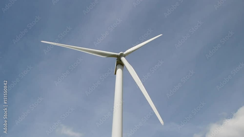 wind turbine in clear blue sky turning - view from the ground wind turbine in clear blue sky turning - view from the ground