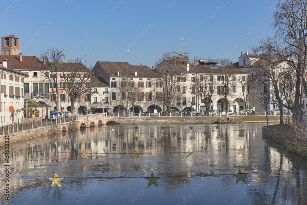 Old palaces with reflections along the river in town Treviso