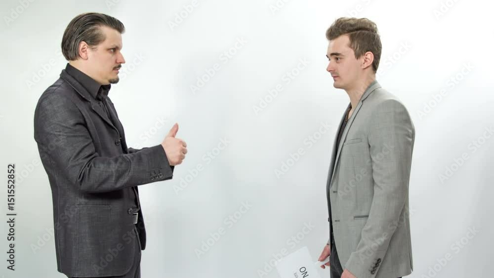 A person is saying something and the other person refuses it. Then he tries to persuade him with some money. A person is saying something and the other person refuses it. Then he tries to persuade him with some money.