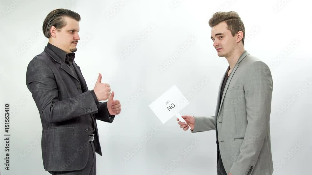 A young man is not agreeing with something that another person says and when the first person shows a gun and points it towards him, he quickly changes his mind and agrees to what he says. A young man is not agreeing with something that another person says and when the first person shows a gun and points it towards him, he quickly changes his mind and agrees to what he says.
