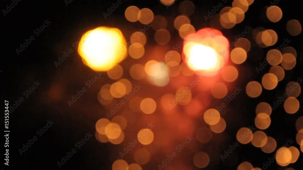 Orange, white and green balls of fireworks opening one from another. Bokeh. Orange, white and green balls of fireworks opening one from another. Bokeh.