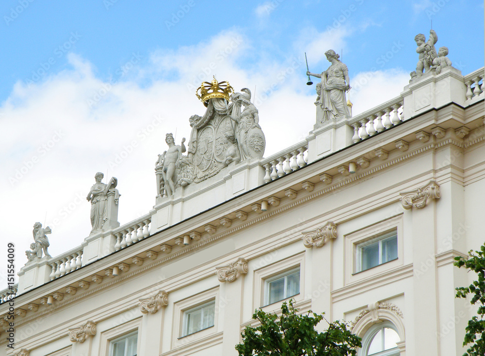 Stunning facade with many beautiful sculptures of a white building in Vienna,  Austria 