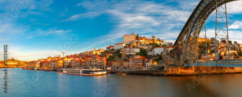 Panorama of Douro river, Ribeira and Dom Luis I or Luiz I iron bridge in the sunny morning Porto, Portugal. photo