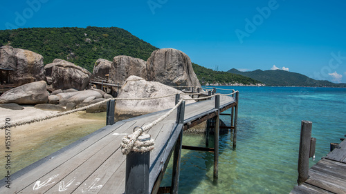 Mountain sea view, wooden pier and blue sky scenery.