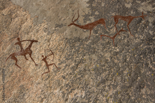 Picture in the cave. On the wall with ocher paints. Caveman hunted animals deer. Neanderthal, primitive, aboriginal, weapons, bow and arrows. The Stone Age, history, science, anthropology