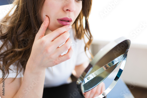 Woman sitting by the mirror photo