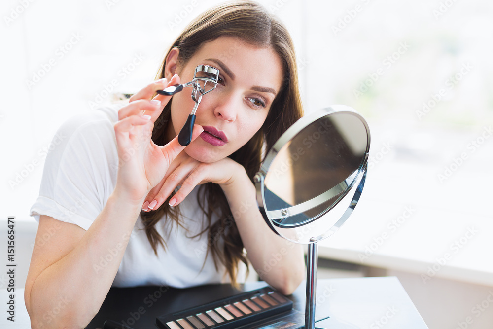 Woman sitting by the mirror