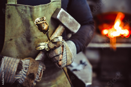 Blacksmith holding forged rose