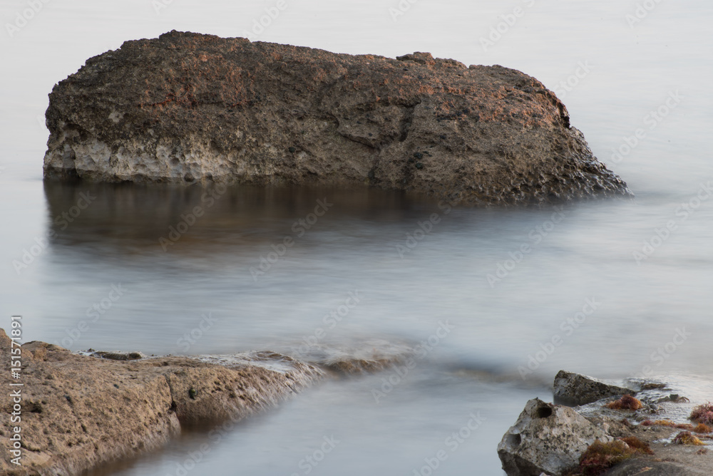 Rocks in the sea with smooth flowing water Rocks in the sea with smooth flowing water