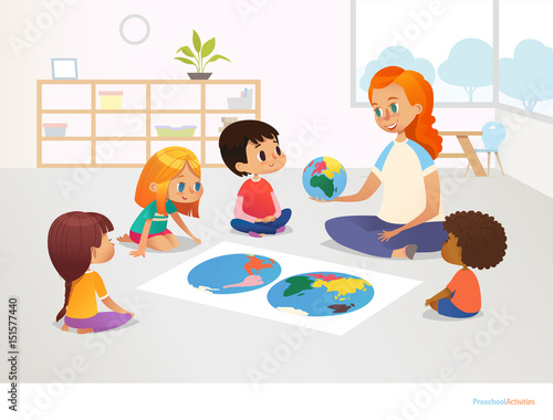 Children sit around world map and redhead female teacher demonstrates them model of planet Earth. Geography lesson at primary school concept. Vector illustration for poster, postcard, advertisement.