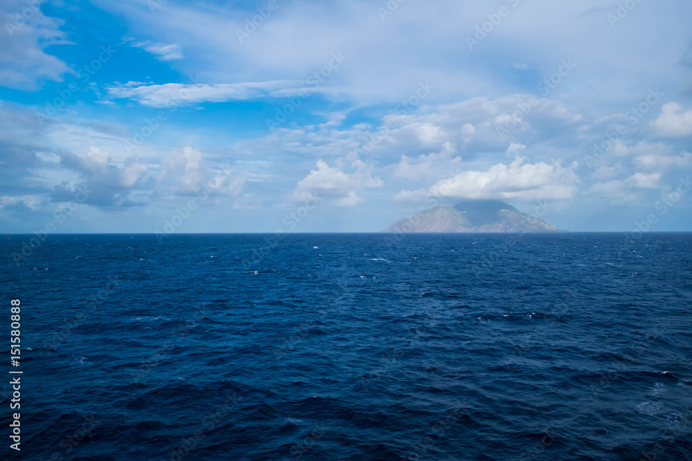 Fototapeta premium Watching an island from a boat; cloudy day