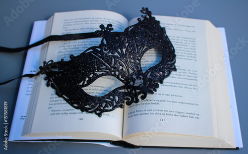 Picture of a crime novel and a mask. photo