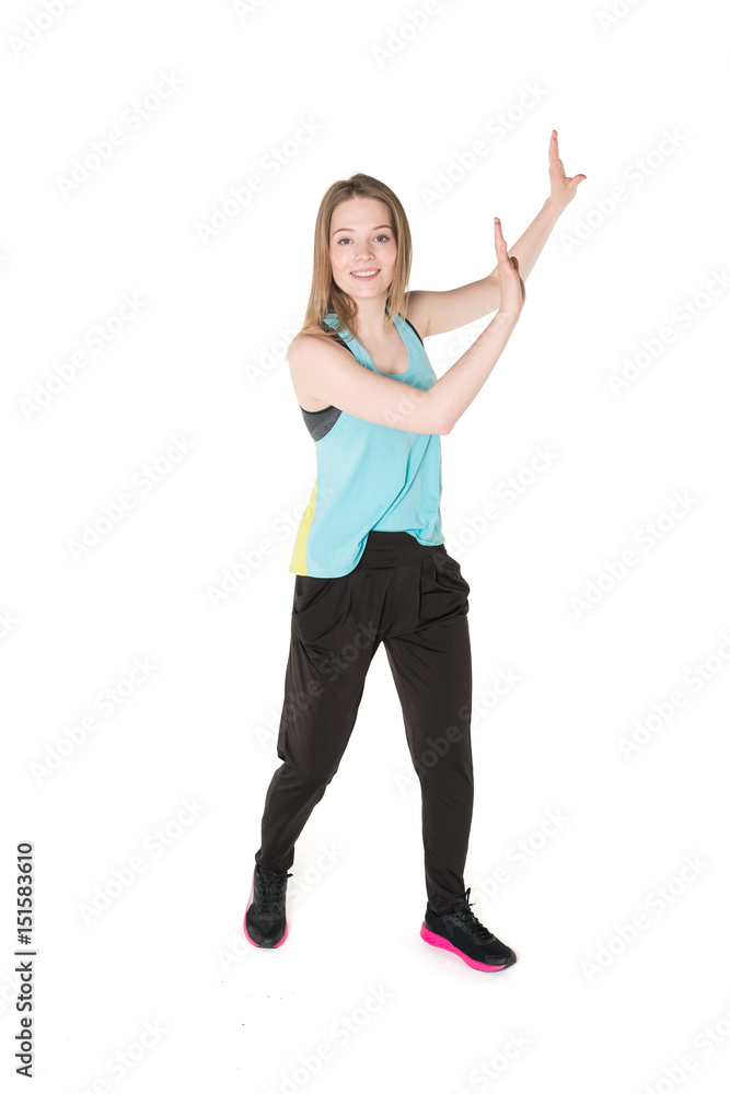 Young, pretty natural looking girl in sport t -shirt and jogging pants having fun dancing. Full body studio shot, pure white background. Young, pretty natural looking girl in sport t -shirt and jogging pants having fun dancing. Full body studio shot, pure white background.