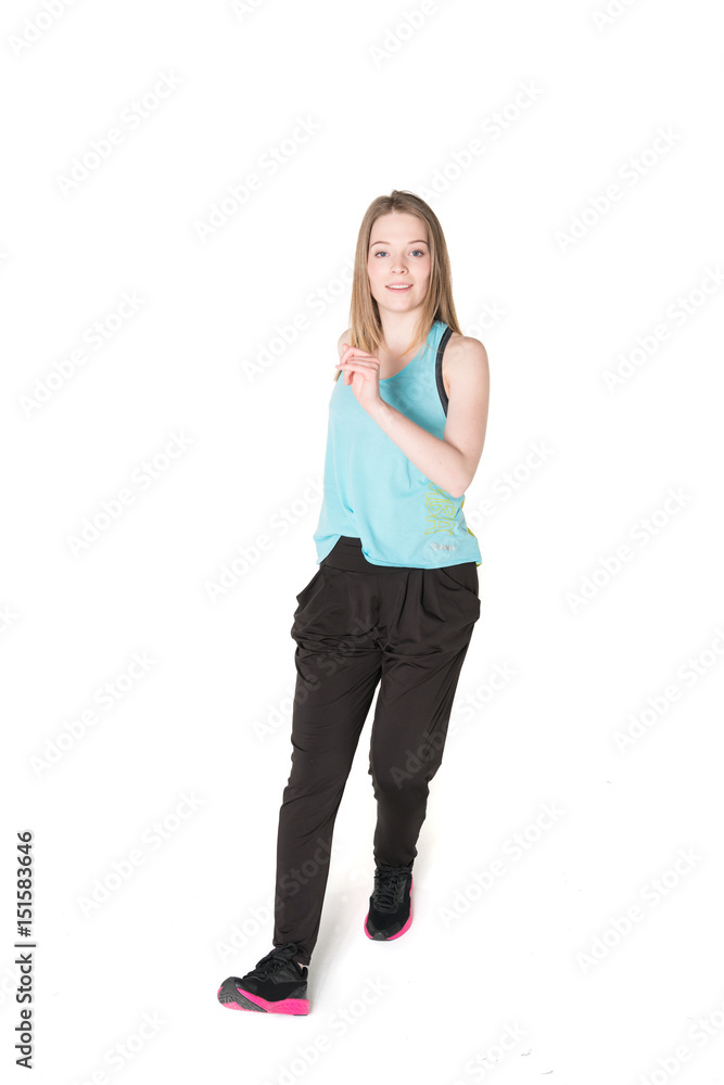 Young, pretty natural looking girl in sport t -shirt and jogging pants having fun dancing. Full body studio shot, pure white background. Young, pretty natural looking girl in sport t -shirt and jogging pants having fun dancing. Full body studio shot, pure white background.