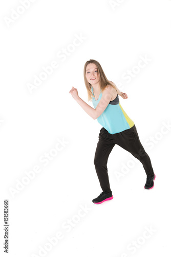 Fototapeta Naklejka Na Ścianę i Meble -  Young, pretty natural looking girl in sport t -shirt and jogging pants having fun dancing. Full body studio shot, pure white background.