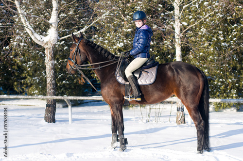 Ten years girl riding a horse in winter © GrasePhoto