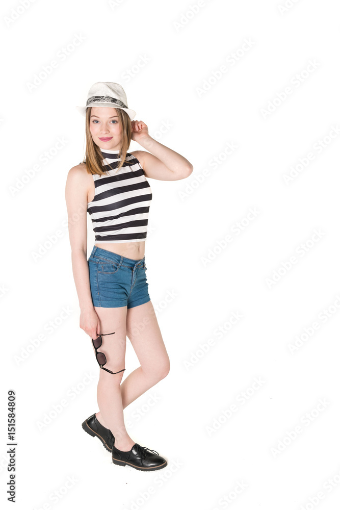 Young, pretty teenager standing with blue shorts and colorful bikini top. studio shot on pure isolated white background Young, pretty teenager standing with blue shorts and colorful bikini top. studio shot on pure isolated white background