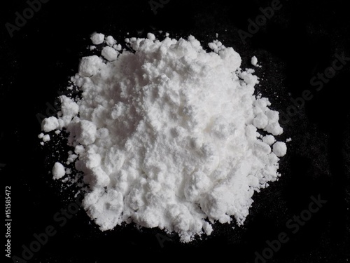 Cocaine drug powder pile on black background
