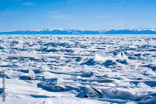 Ice hummocks of the frozen Lake Baikal, Siberia, Russia. On the other side of the lake the Khamar-Daban Range is visible 