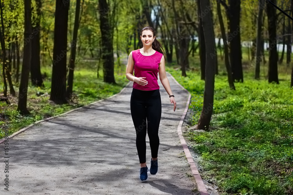 Young pretty fit woman jogging in the park. Young pretty fit woman jogging in the park.
