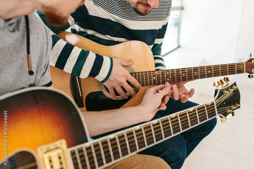 Obraz premium Learning to play the guitar. Music education.