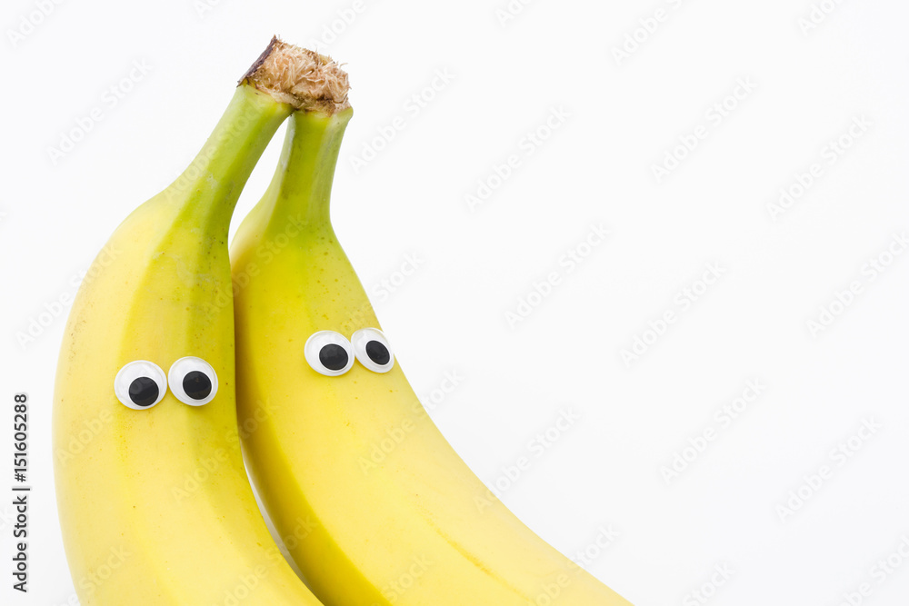 bananas with googly eyes on white background banana face Stock Photo