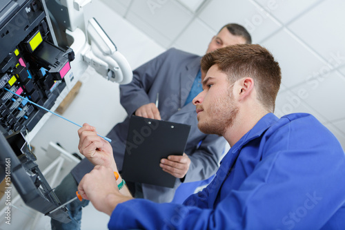 Man servicing photocopier