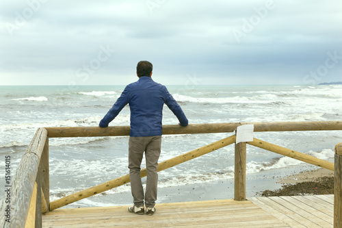 Fototapeta Naklejka Na Ścianę i Meble -  lonely men looking at the sea