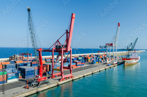 View of commercial port with rail cranes and boat