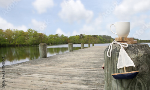 White cup and boat near dock