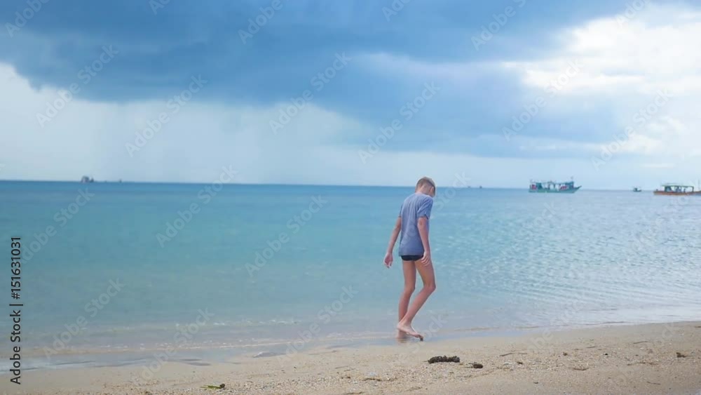 the boy goes along the sea shore the boy goes along the sea shore