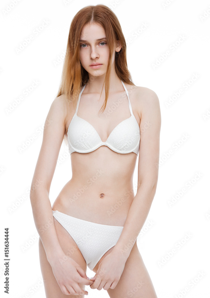 Fototapeta premium Young fit fashion model wearing white bikini