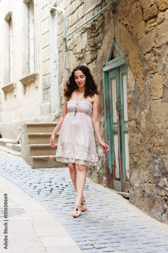Young girl strolling through narrow streets Young girl strolling through narrow streets