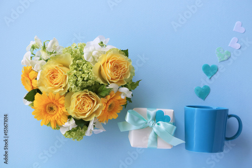 Heart shaped bouquet of yellow roses  gift boxes and mug cup with heart                                                          