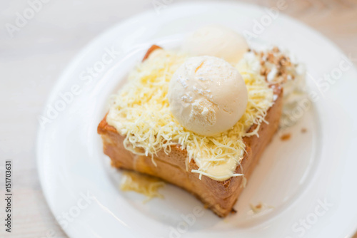 Chesse toast with ice-cream on white dish.