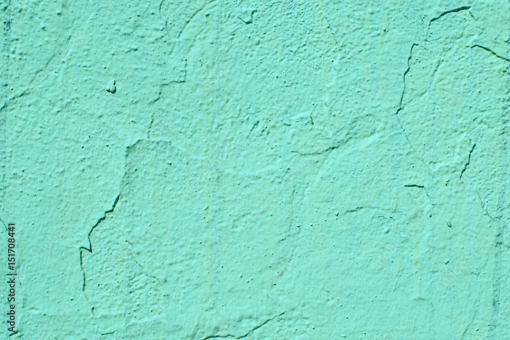 An old cracked wall of aquamarine color