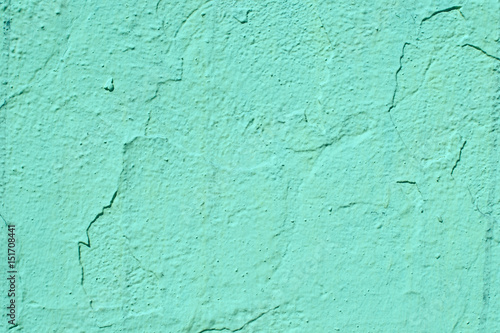 An old cracked wall of aquamarine color