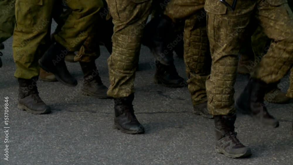 Soldiers in camouflage marching during parade on square. Closeup of feet Soldiers in camouflage marching during parade on square. Closeup of feet