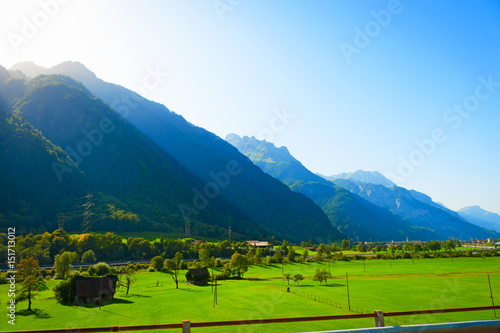 andscape with big green mountain meadow in in the Switzerland Alps