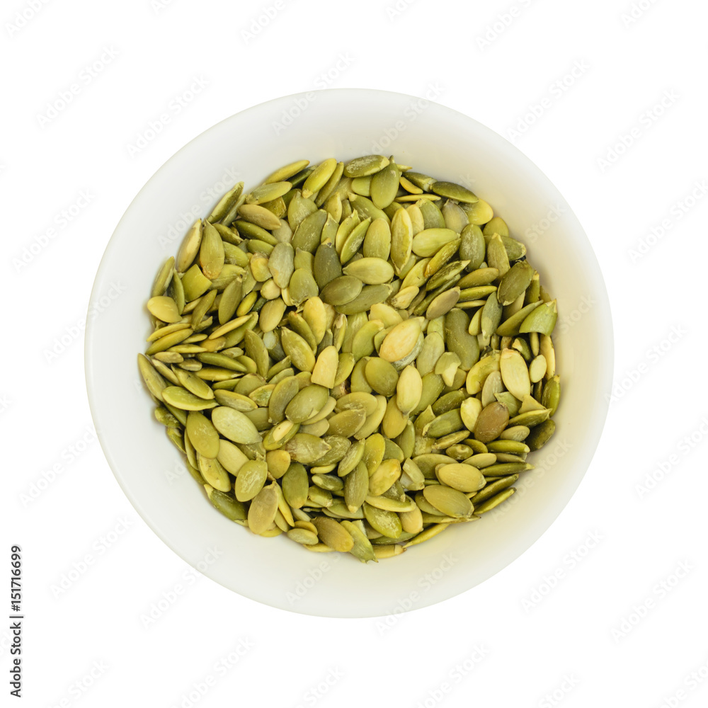 Pumpkin seeds in a bowl isolated on white Pumpkin seeds in a bowl isolated on white