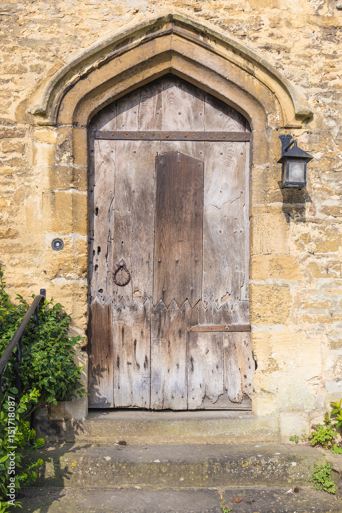 old european wooden door on thick stone wall old european wooden door on thick stone wall